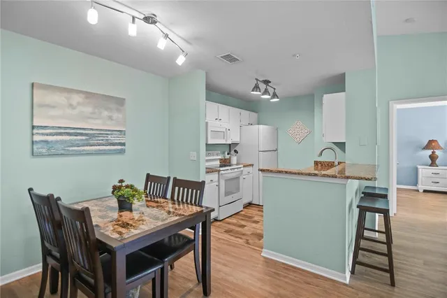 a kitchen with a table and chairs in it
