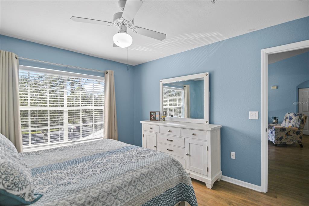 7417 Vista Way, Unit 202 Lakewood Ranch, FL 34202 - Photo 15 of 56 a bedroom with a bed and a dresser