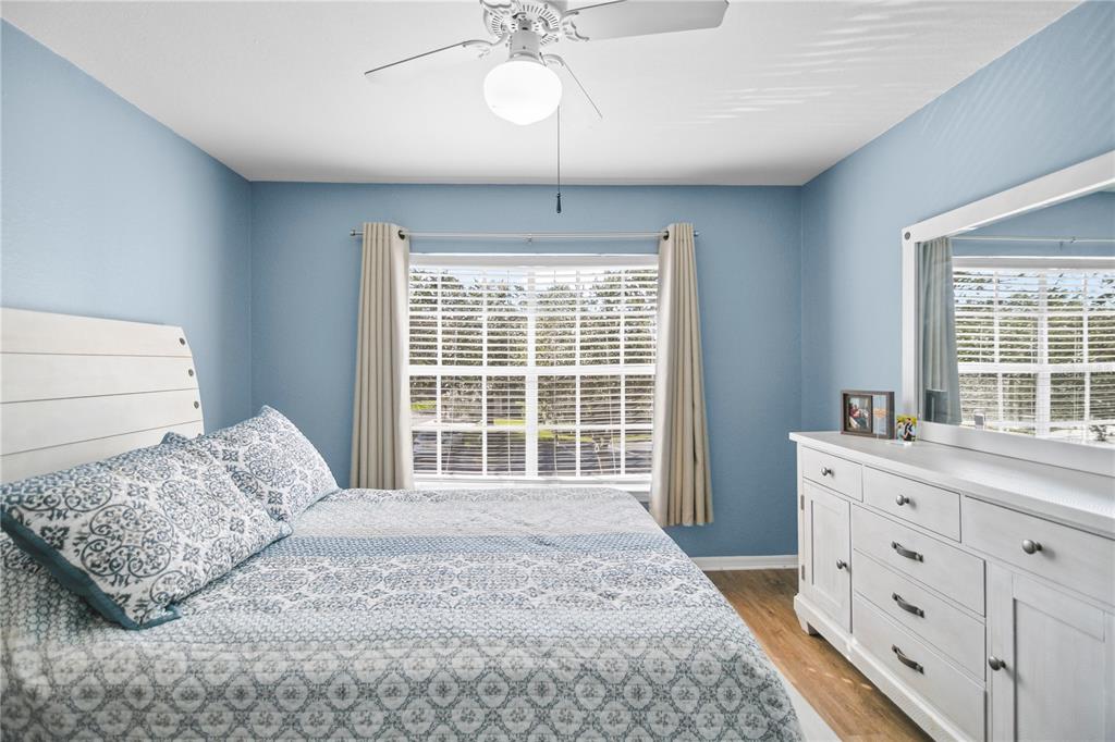 7417 Vista Way, Unit 202 Lakewood Ranch, FL 34202 - Photo 16 of 56 a bedroom with a large bed and a window