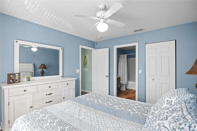 a bedroom with a large bed and a chandelier