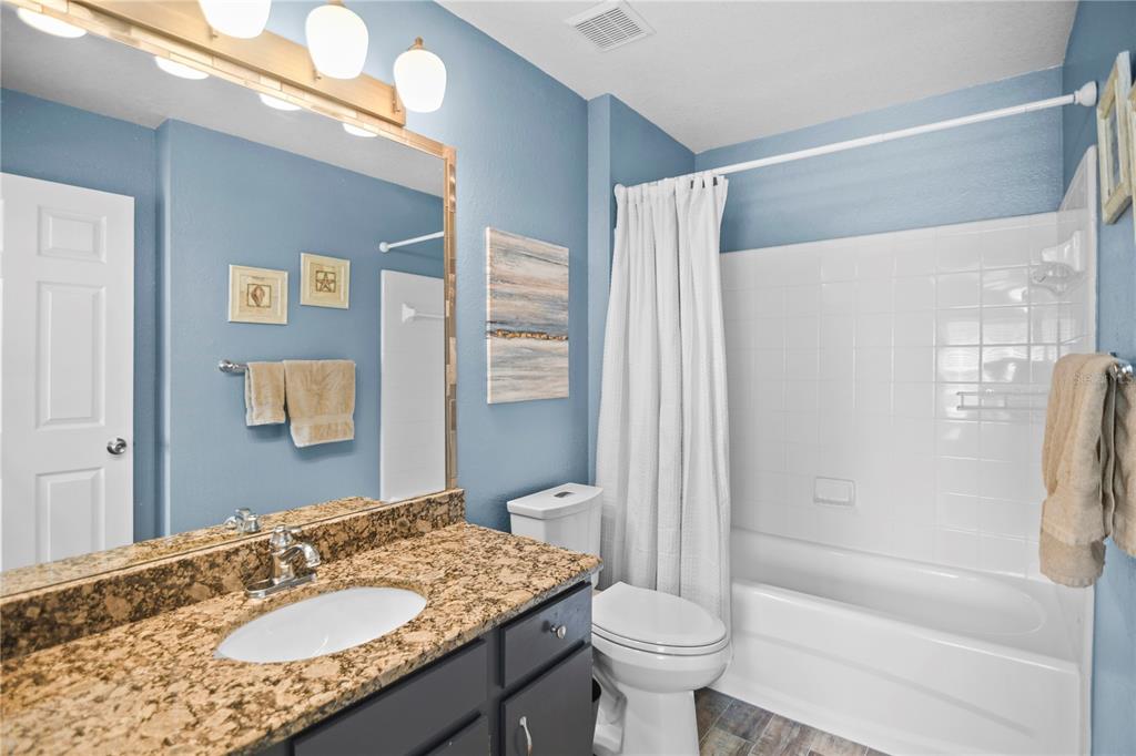 7417 Vista Way, Unit 202 Lakewood Ranch, FL 34202 - Photo 18 of 56 a bathroom with a granite countertop sink toilet and shower