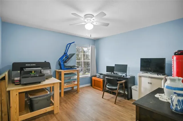 a view of a workspace with furniture and wooden floor