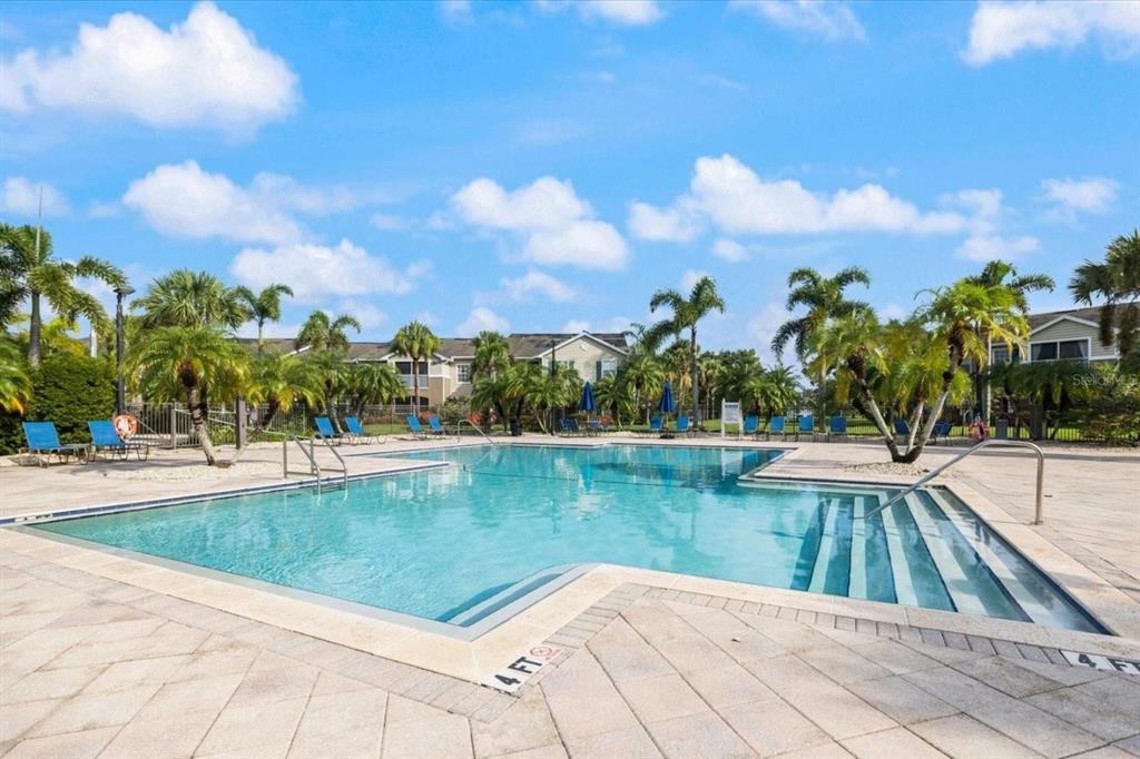 7417 Vista Way, Unit 202 Lakewood Ranch, FL 34202 - Photo 32 of 56 a view of a swimming pool and trees in the background