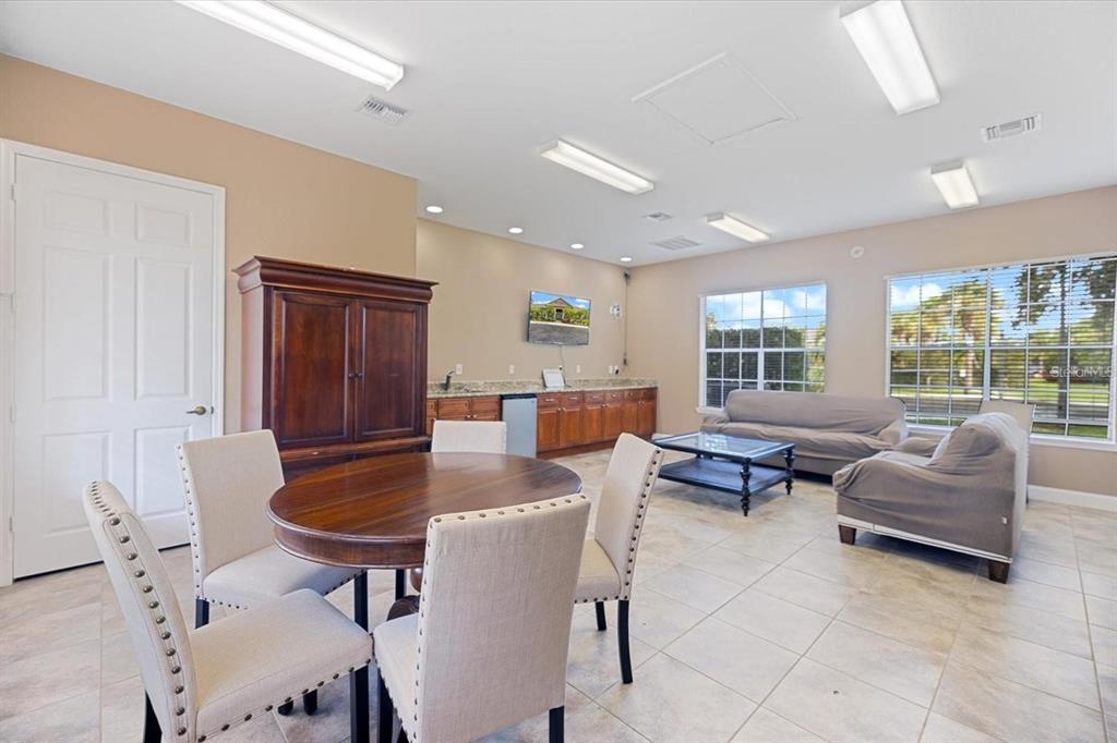 7417 Vista Way, Unit 202 Lakewood Ranch, FL 34202 - Photo 35 of 56 a living room with furniture and a table
