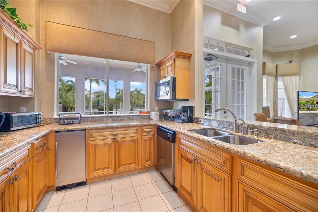 7417 Vista Way, Unit 202 Lakewood Ranch, FL 34202 - Photo 36 of 56 a kitchen with a sink stove and cabinets