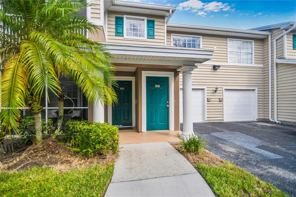 7417 Vista Way, Unit 202 Lakewood Ranch, FL 34202 - Photo 4 of 56 a view of a house with potted plants and a large window