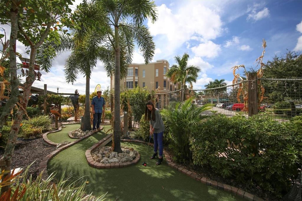 7417 Vista Way, Unit 202 Lakewood Ranch, FL 34202 - Photo 48 of 56 a view of a backyard with plants and a fountain