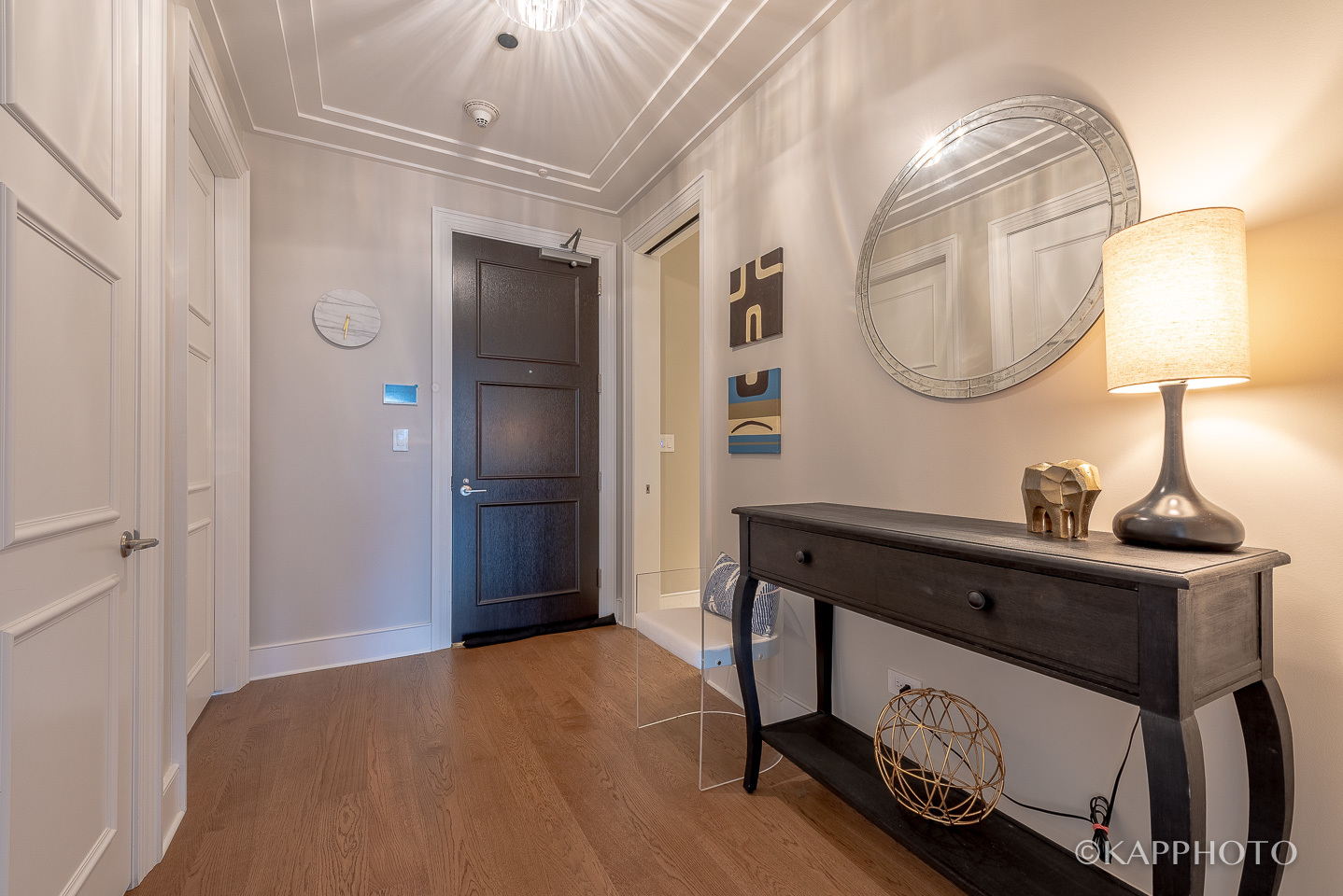 118 East Erie Street, Unit 15A Chicago, IL 60611 - Photo 5 of 28 a bedroom with a bed and a mirror