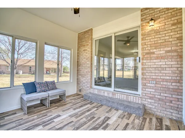 a living room with furniture and floor to ceiling windows