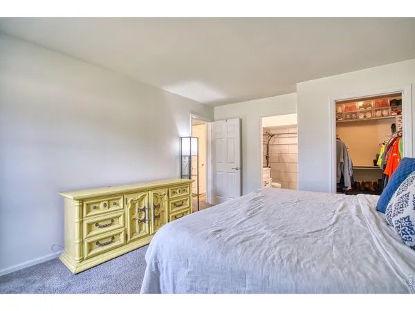 a spacious bedroom with a bed and a window