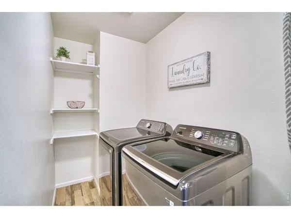a bathroom with a granite countertop sink a toilet a mirror and bathtub