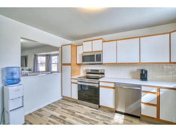 a kitchen with stainless steel appliances a stove sink microwave and cabinets