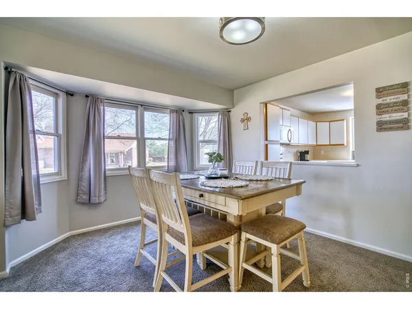 a kitchen with stainless steel appliances granite countertop a refrigerator a stove and a sink