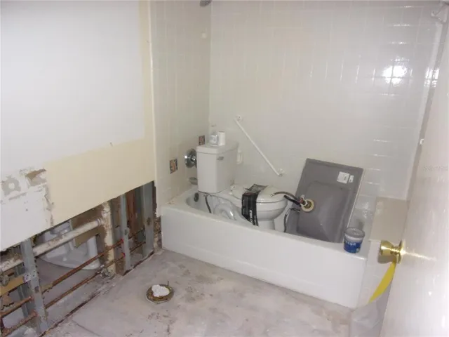 a view of a house with a yard and a patio