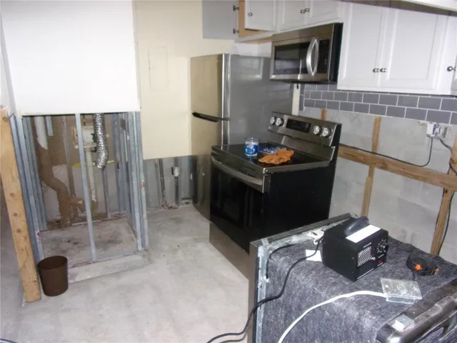a kitchen with stainless steel appliances granite countertop a stove and a refrigerator
