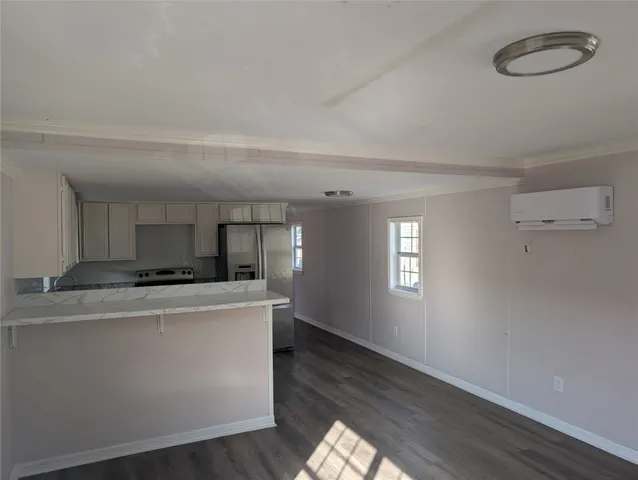 a kitchen with granite countertop a sink and white cabinets