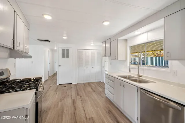 a kitchen with a sink stove and cabinets