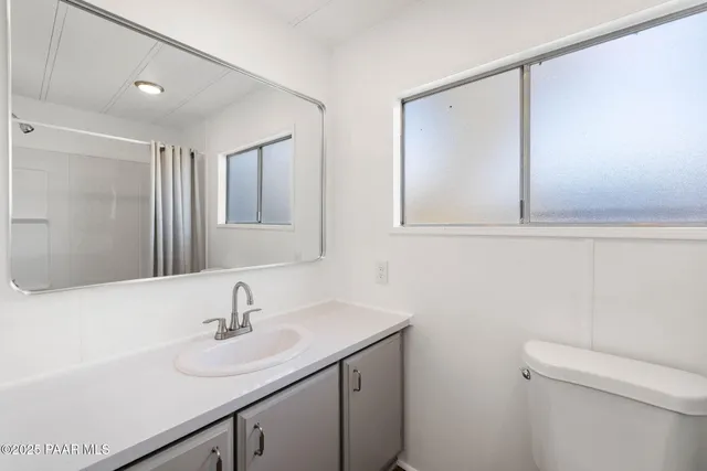 a bathroom with a sink toilet and mirror