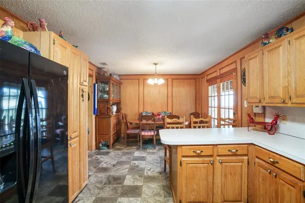 a kitchen with a sink a refrigerator and cabinets