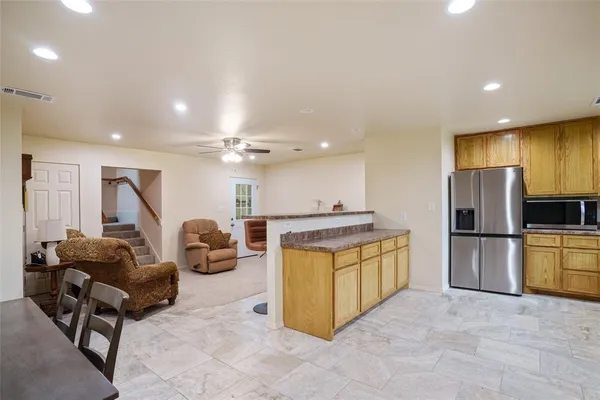 a kitchen with sink refrigerator and microwave