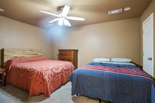 a bedroom with two beds and a chandelier