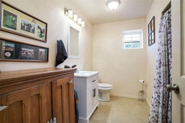 a bathroom with a toilet a sink and a mirror