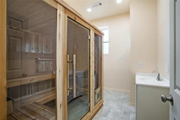 a bathroom with a shower and a sink