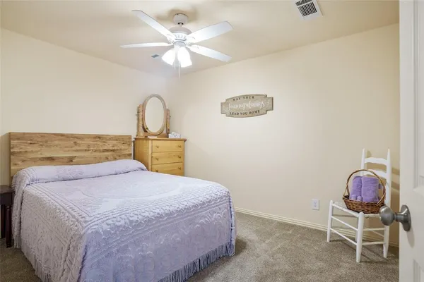 a bedroom with a bed and a chair