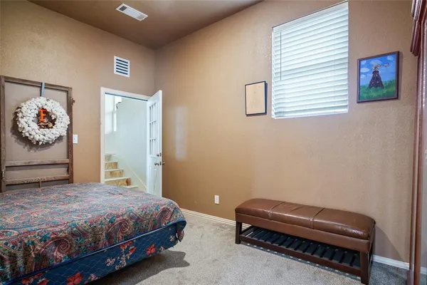 a bedroom with a bed and a couch