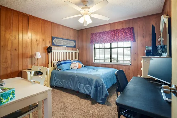 a bedroom with a bed window and table