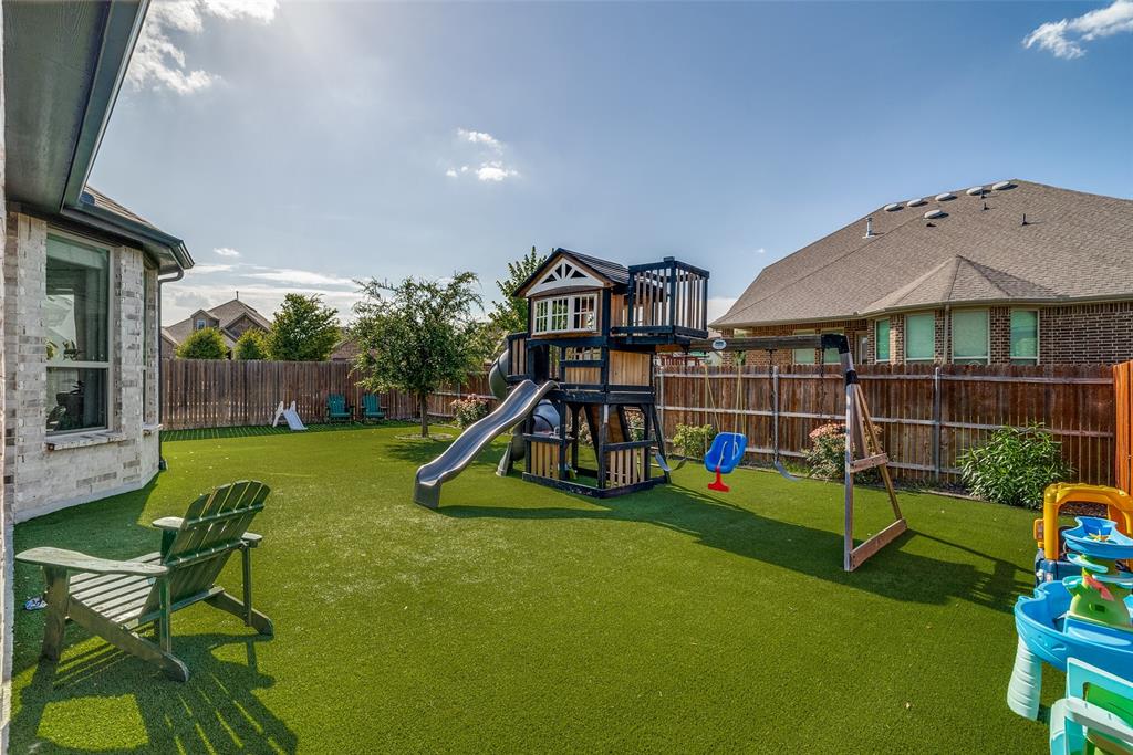 14948 Gentry Drive Aledo, TX 76008 - Photo 24 of 25 Expansive backyard featuring artificial turf, a wood privacy fence