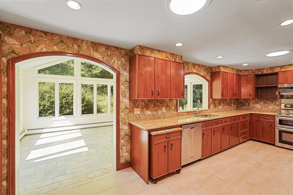 165 Barre Paxton Road Rutland, MA 01543 - Photo 24 of 42 a large kitchen with stainless steel appliances granite countertop a stove and cabinets