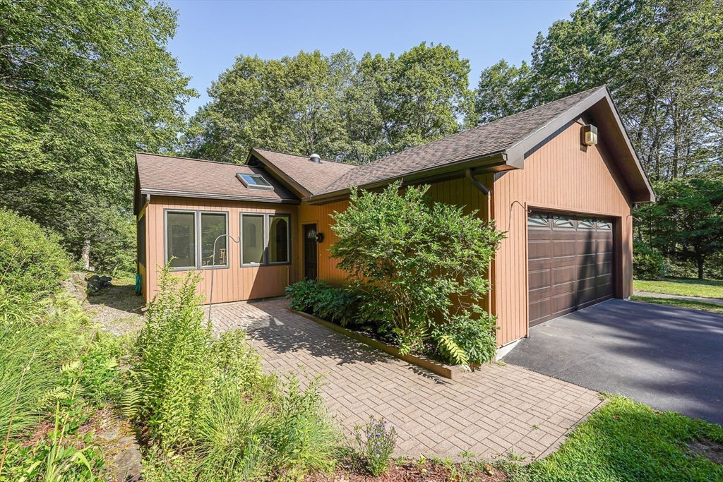 165 Barre Paxton Road Rutland, MA 01543 - Photo 3 of 42 a front view of a house with a yard and trees