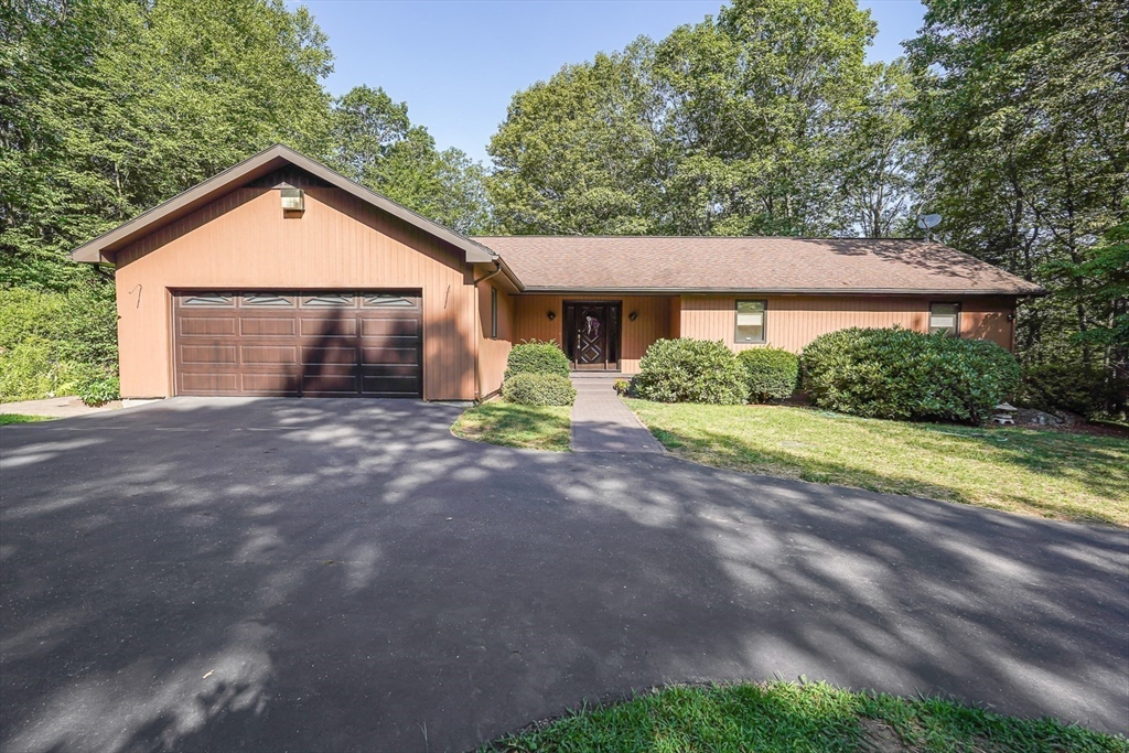165 Barre Paxton Road Rutland, MA 01543 - Photo 4 of 42 a front view of a house with a yard and garage