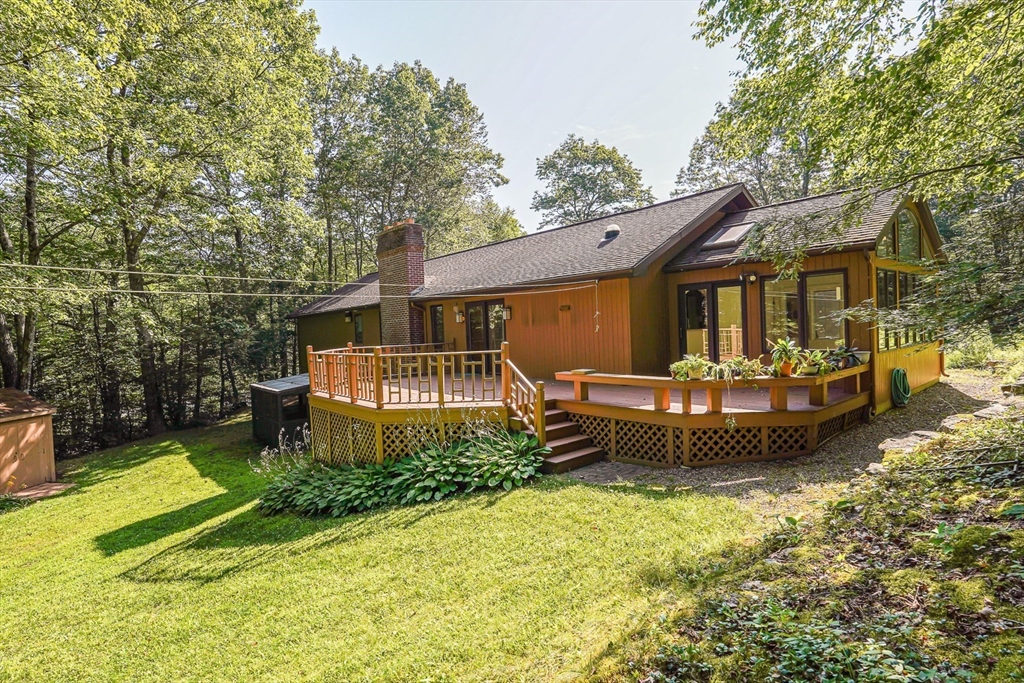 165 Barre Paxton Road Rutland, MA 01543 - Photo 5 of 42 a front view of a house with a garden