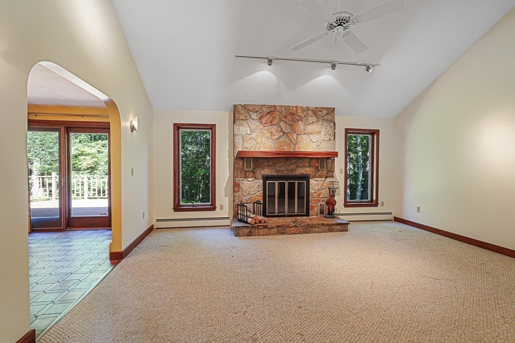 165 Barre Paxton Road Rutland, MA 01543 - Photo 7 of 42 an empty room with fireplace and windows