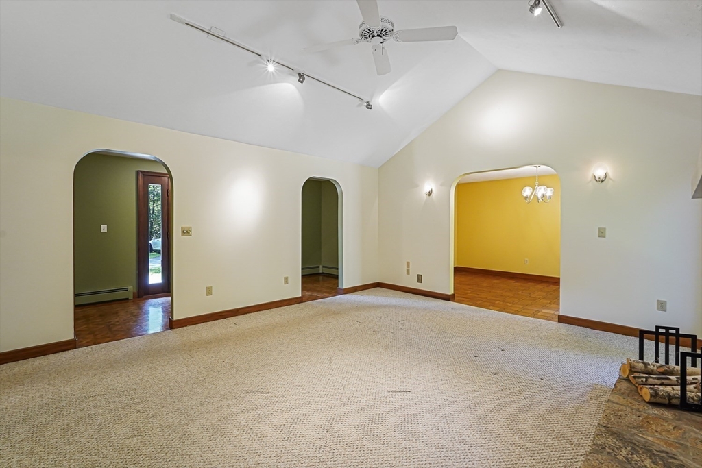165 Barre Paxton Road Rutland, MA 01543 - Photo 9 of 42 an empty room with a flat screen tv and couches