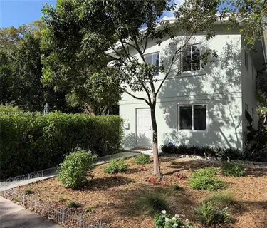 a front view of a house with garden