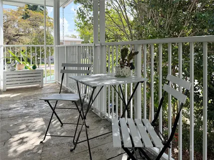 a view of balcony with wooden floor and outdoor seating