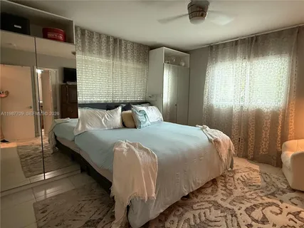 a bedroom with a bed and a lamp