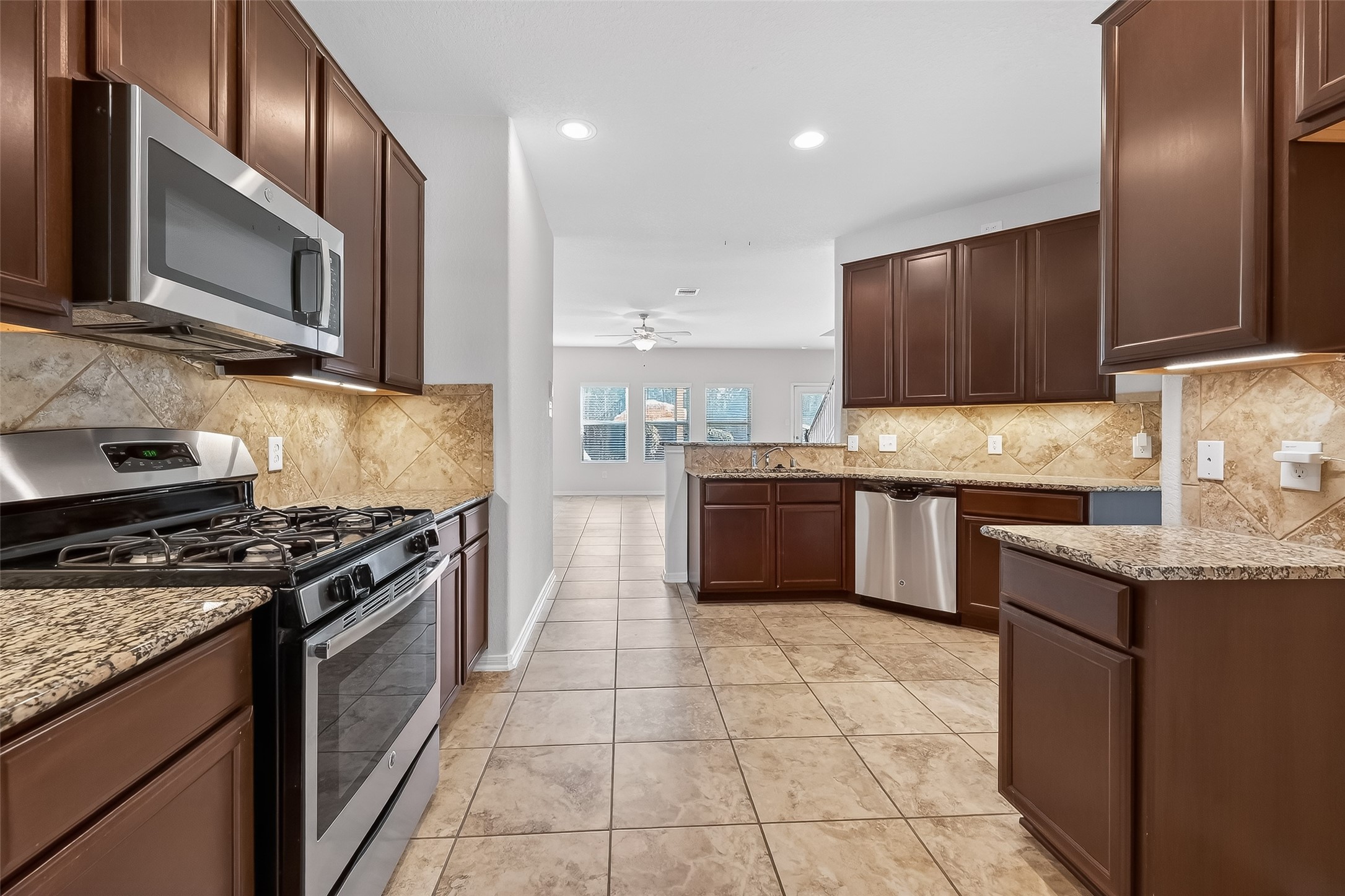 2672 Magnolia Fair Way Spring, TX 77386 - Photo 12 of 49 Kitchen open to and overlooking the living room, creating a seamless, connected living space.