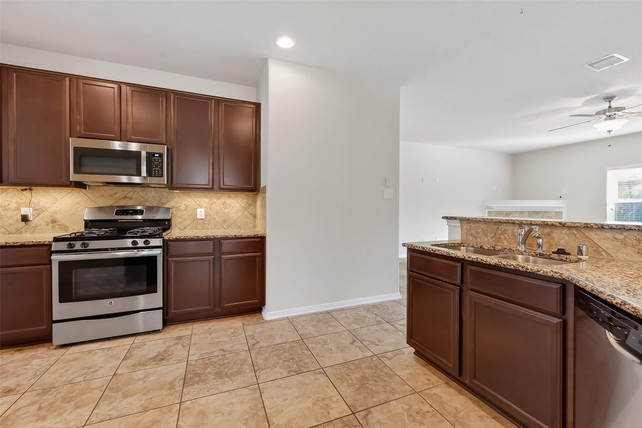 2672 Magnolia Fair Way Spring, TX 77386 - Photo 13 of 49 Bright kitchen featuring elegant under-cabinet lighting.