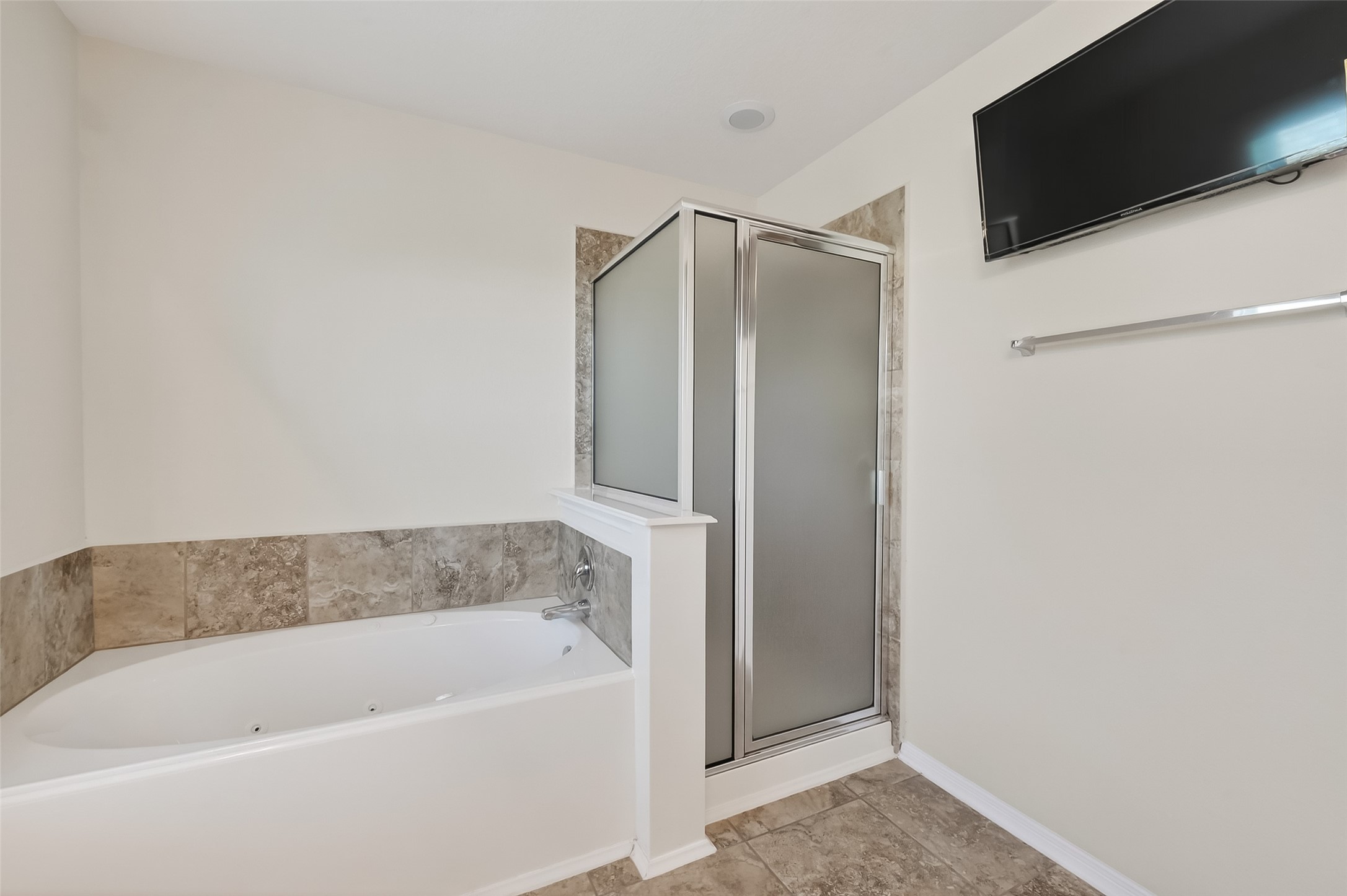 2672 Magnolia Fair Way Spring, TX 77386 - Photo 34 of 49 Luxurious primary bathroom featuring a jetted tub, walk-in shower, and wall-mounted TV for ultimate relaxation.