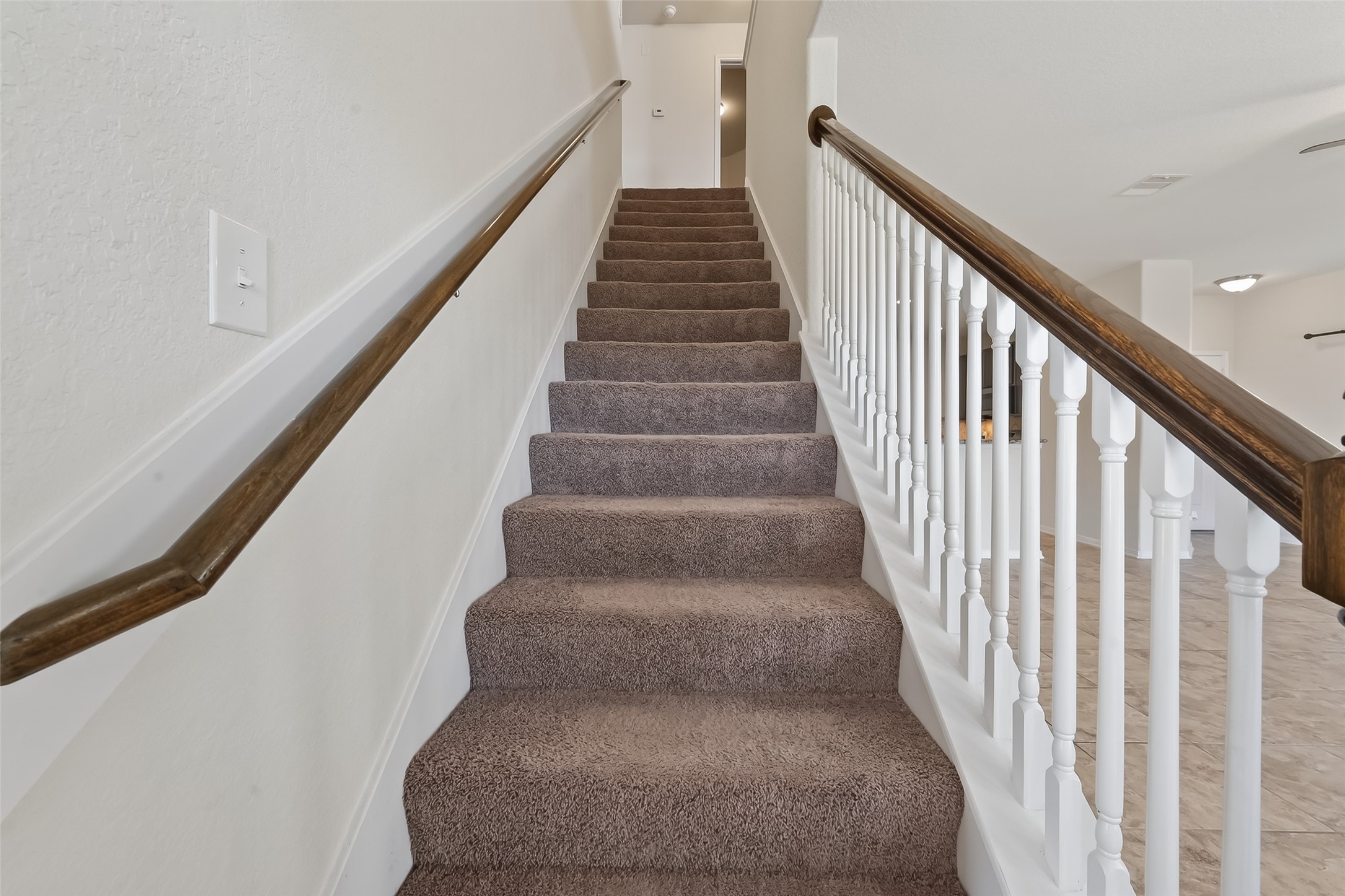 2672 Magnolia Fair Way Spring, TX 77386 - Photo 35 of 49 Ascend to your private retreat, featuring inviting carpeted stairs and elegant railings.