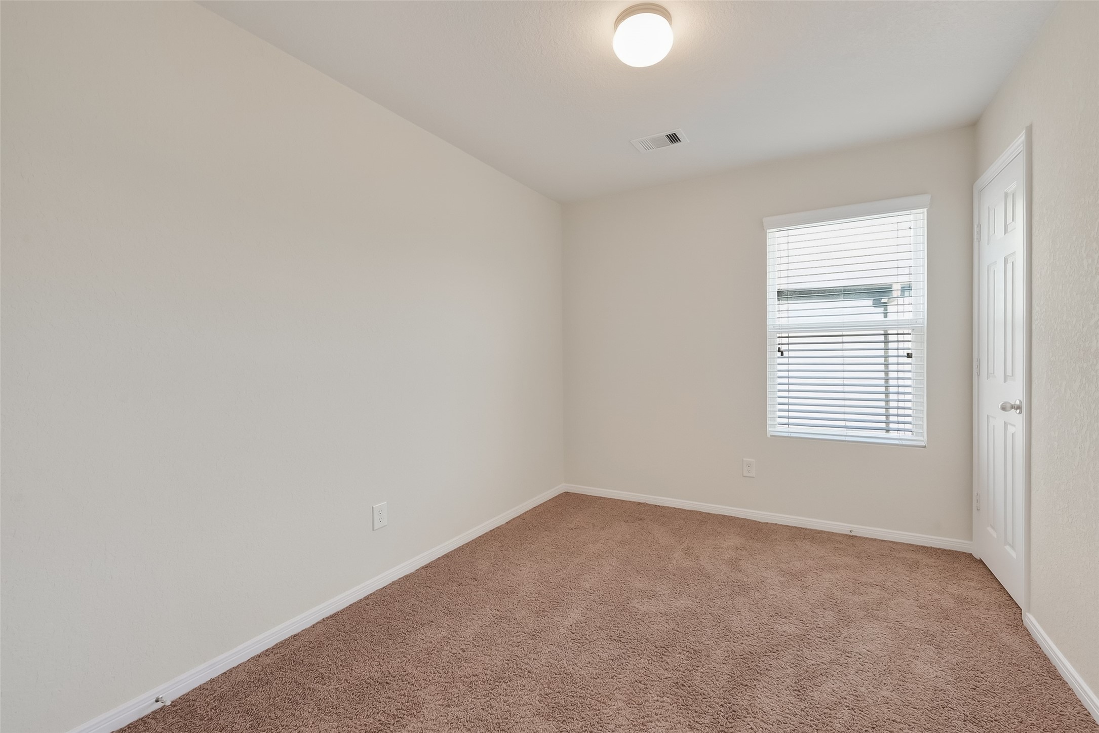 2672 Magnolia Fair Way Spring, TX 77386 - Photo 36 of 49 Modern secondary bedroom with cozy carpeting and ample natural light.