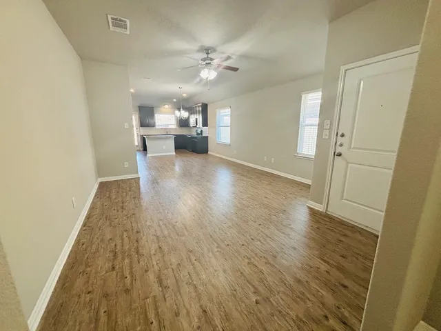 a view of a kitchen from a hallway