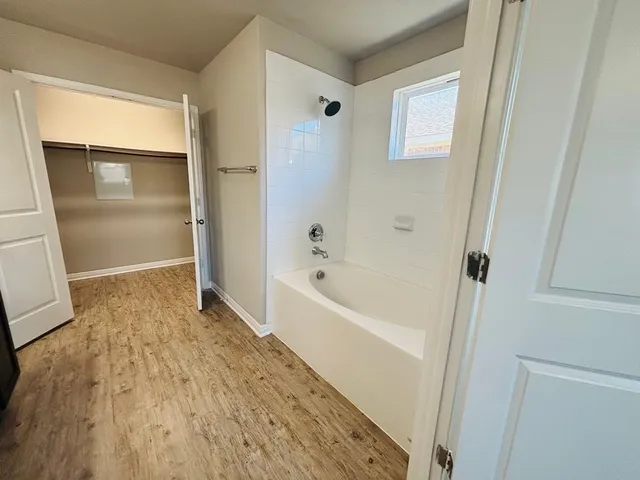 a bathroom with a bathtub and shower