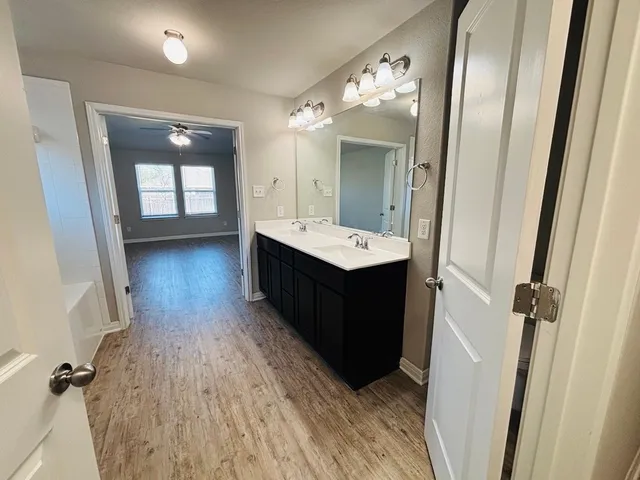 a bathroom with a sink a mirror and a shower