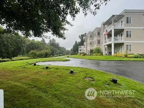 17426 Northeast Bothell Way, Unit A 107 Bothell, WA 98011 - Photo 1 of 11 a view of swimming pool with a garden and plants
