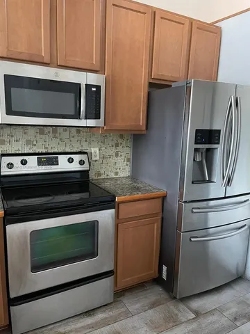 a kitchen with appliances and cabinets